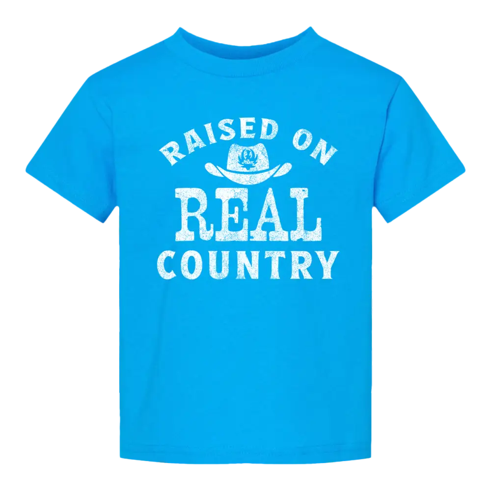 Blue t-shirt with ’Raised on Real Country’ text.