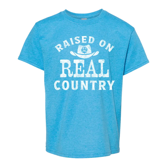 Blue t-shirt with ’Raised on Real Country’ text.
