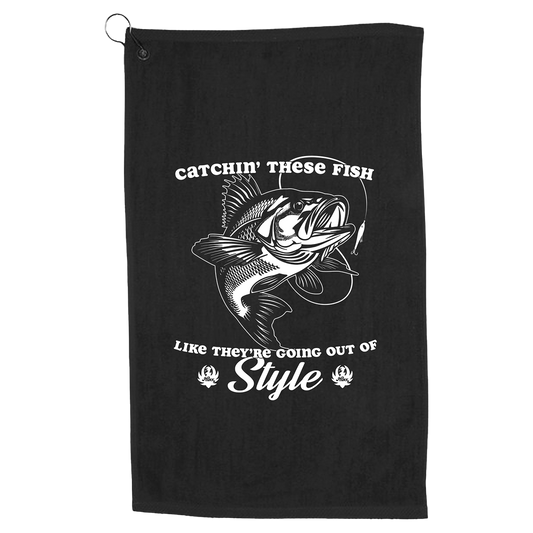 Black towel or cloth with a fishing-themed graphic and text design.