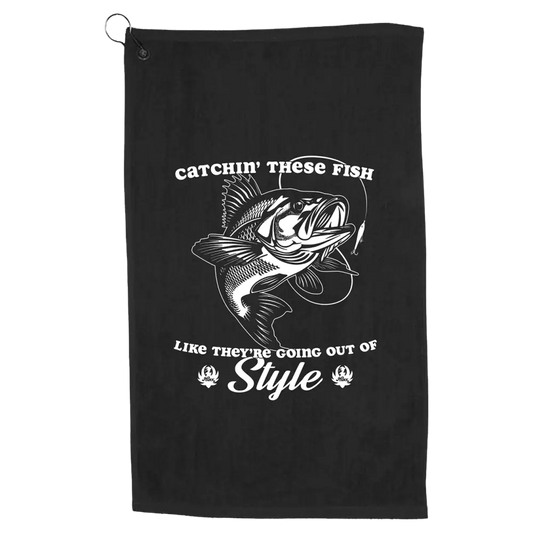 Black towel or cloth with a fishing-themed graphic and text design.