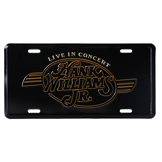 License plate featuring ’Hank Williams Jr. Live in Concert’ logo in gold lettering on a black background.